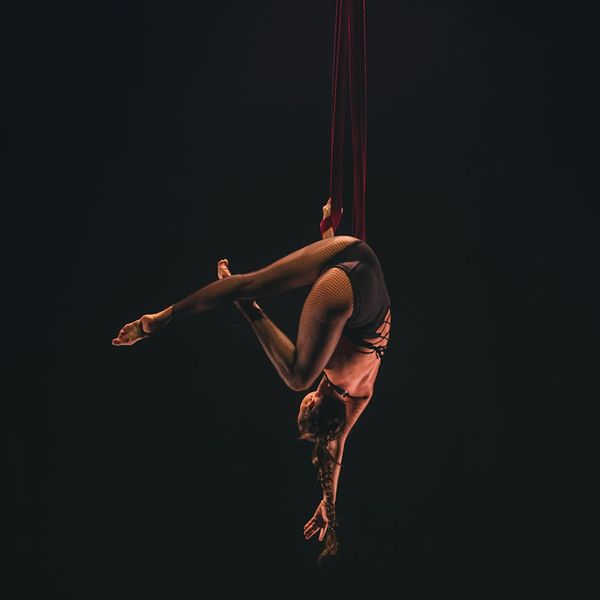 Elegant silhouette of a woman stretching, showing flexibility and strength.